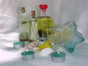 Lit candles and shells surround bottles of Aromagick oils