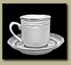 Black and white photo of a porcelain coffee cup with a handle on a saucer