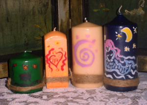 Four voodoo candles of various heights and colors
